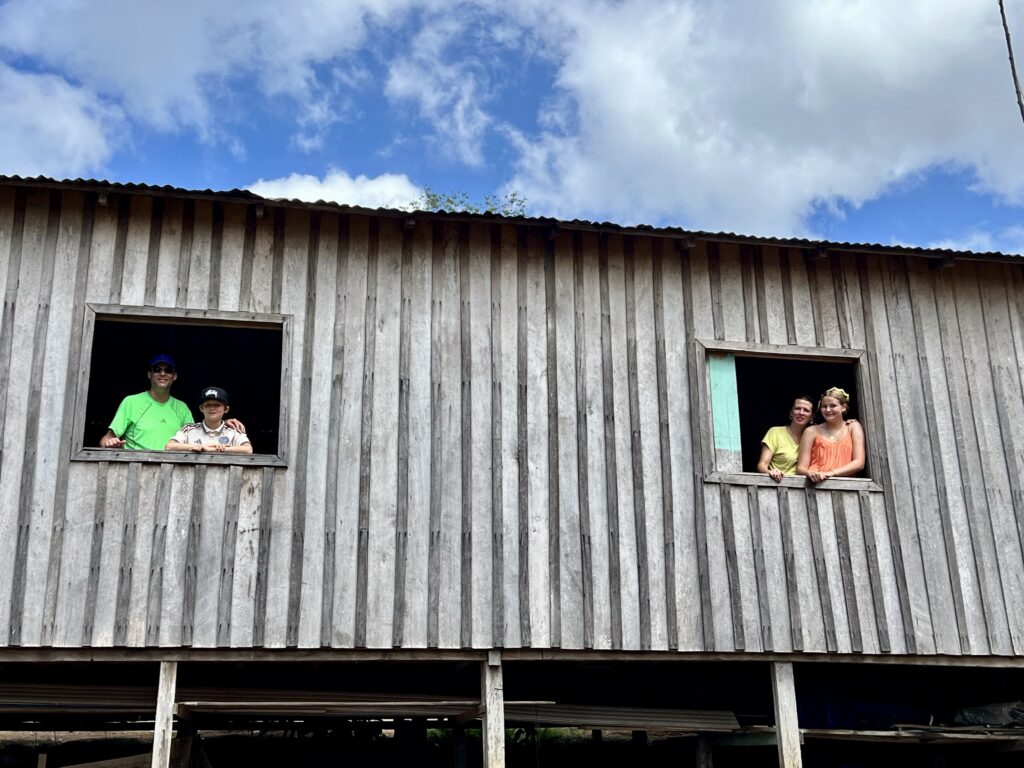Family visiting a riverside community house