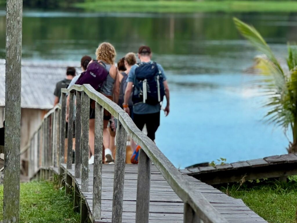 Guests walking the boardwalk toward the lake