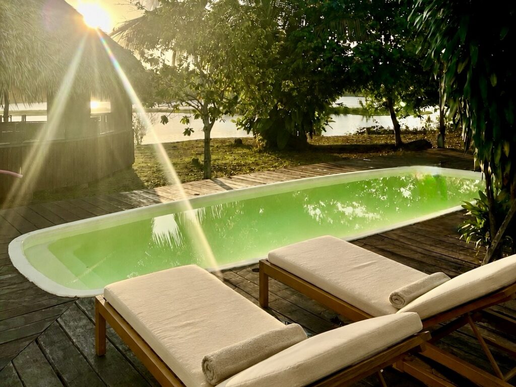Pool deck with sun loungers at golden hour
